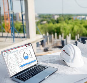 Hydraulic calculation software on laptop at construction site